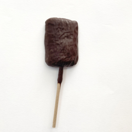 Salmiak lollypop covered in dark chocolate, german