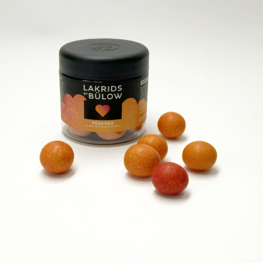Box with liquorice marbles in white chocolate and peach by johan buelow, danish