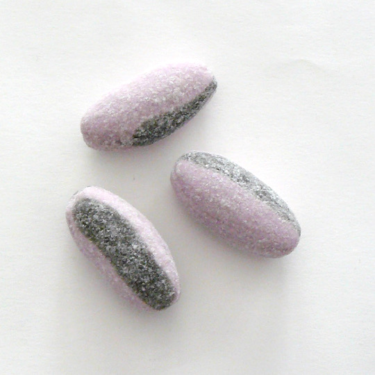 Liquorice candy with powder filling salmiac and violet, swedish