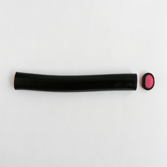 Mild liquorice cane filled with strawberry, finnish