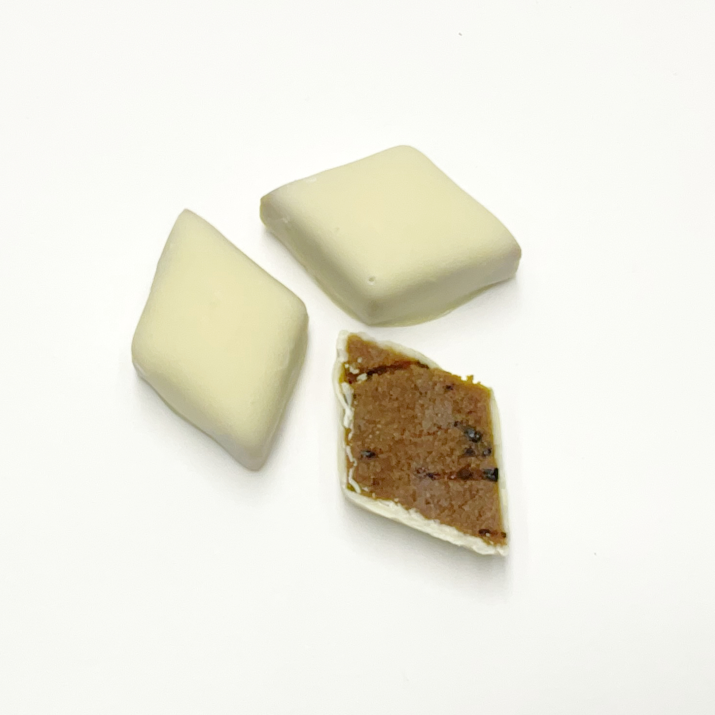 Fine pralines marzipan with liquorice covered with white chocolate, handmade, german