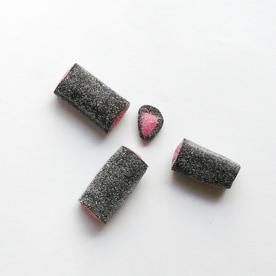 Sprinkled liquorice  rolls filled with raspberry, finnish