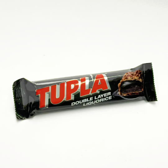 Bar sweet and crispy liquorice toffee with chocolate and puffed rice, finnish